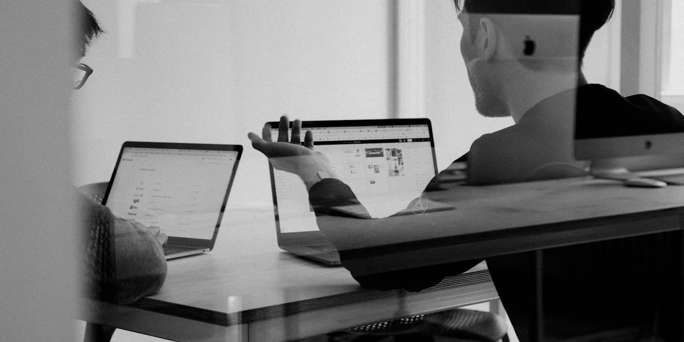 Team members connecting ideas and systems in an open office.